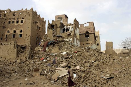 A man walks past houses damaged by Saudi-led airstrikes in Yemen's northwestern city of Saada May 26, 2015. Picture taken May 26, 2015. REUTERS/Stringer      TPX IMAGES OF THE DAY      - RTX1EQNS